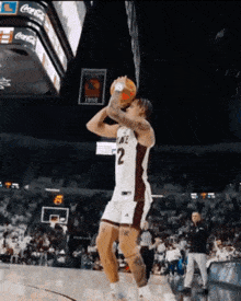 a basketball player with the number 2 on his jersey is jumping in the air