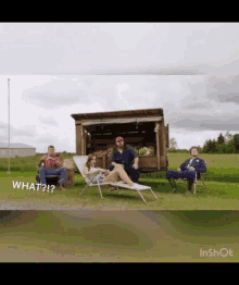 a group of people are sitting in lawn chairs in front of a truck that says " what "