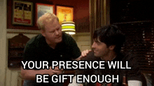 two men are sitting at a table with the words your presence will be gift enough
