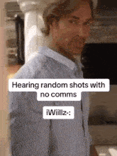 a man in a striped shirt is standing in front of a sign that says hearing random shots with no comms .