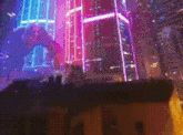 a blurry picture of a city at night with lots of neon lights and a building in the foreground .
