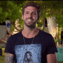 a man wearing a black t-shirt with a picture of a woman on it