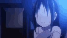 a girl with long black hair is covering her face with her hand