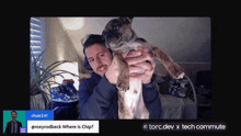 a man is holding a puppy in front of a screen that says ' choir241 ' on it