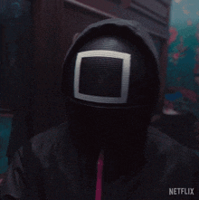 a person wearing a mask and holding a walkie talkie with the words go ahead written on the bottom
