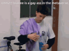 a man in a purple shirt is standing next to a bicycle and drinking from a bottle ..