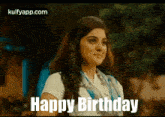 a woman in a white shirt and scarf is smiling and saying happy birthday .