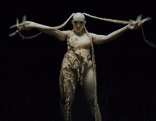 a statue of a woman with dreadlocks and a snake around her neck