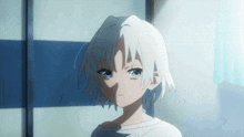 a girl with white hair and blue eyes is standing in front of a blue and white wall