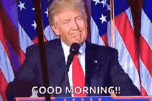 donald trump is giving a speech at a podium in front of an american flag and says `` good morning '' .