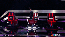 a man sitting in a chair that says " i want you " on it