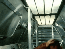 a person is walking up a set of stairs in a room