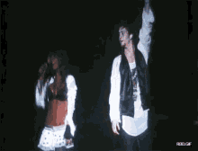 a man and a woman are dancing on a stage with rbd.gif in the lower right corner