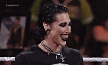 a female wrestler is smiling in a wrestling ring with the hashtag #wweraw