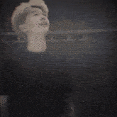 a blurry picture of a person 's face behind a blue block with the letter z on it