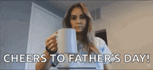 a woman is holding a cup of coffee and says cheers to father 's day !