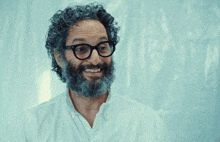 a man with glasses and a beard is pointing at something with the words i crushed it behind him