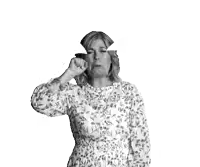 a black and white photo of a woman in a floral dress