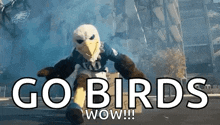 a mascot for the eagles is holding a box and says go birds wow