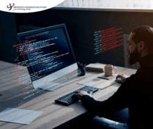 a man sitting in front of a computer with impressico business solutions written on the bottom right