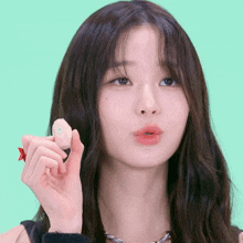 a close up of a woman holding a small object