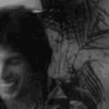 a black and white photo of a man 's face with his mouth open .
