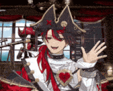 a man in a pirate costume is waving his hand
