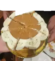 a person is holding a cake with a slice missing