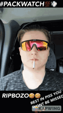 a man wearing sunglasses is smoking a cigarette and says rip bozo rest in piss you won t be missed