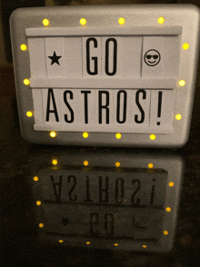 a sign that says " go astros " is lit up