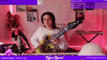 a woman playing an inflatable guitar in front of a keyboard with the words pride & joy below her