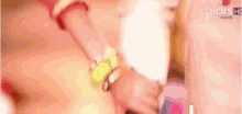 a close up of a person holding a piece of cotton candy in their mouth .