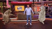 a man is dancing on a stage in front of a sign that says mollica 's