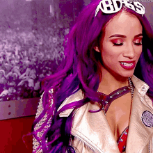 a woman with purple hair wears a headband that says boss