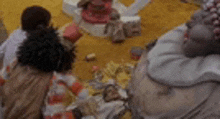 a group of people are sitting around a table with a bunch of toys on it .