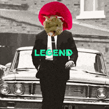 a man in a suit and tie is standing in front of a car with legend written on it