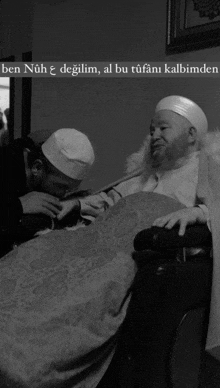 a black and white photo of a man in a wheelchair with the caption ben nuh e degilim al bu tufani kalbimde