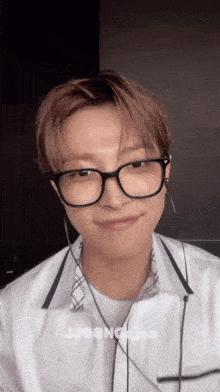a close up of a person wearing glasses and earphones