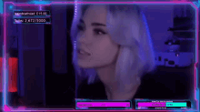 a woman with white hair is sitting in front of a computer screen with neon lights .