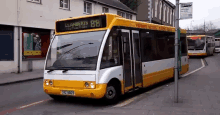 a yellow and white bus with the number 88 on the top