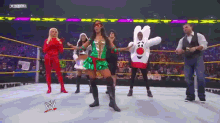 a group of people are dancing in a wrestling ring with a sign that says wwehd in the background