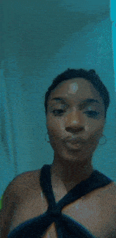 a woman in a black top is taking a selfie