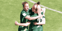 a group of female soccer players are hugging each other and one has the number 21 on her back