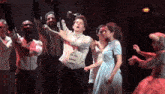 a group of people are dancing on a stage in front of a sign that says ' dept ' on it