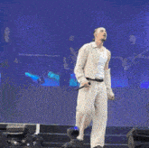 a man singing into a microphone on stage