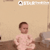 a baby with a star tamil chat logo behind him