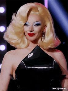 a woman with blonde hair and red lips is wearing a black dress and earrings