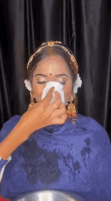 a woman is getting her makeup done by a makeup artist .