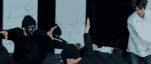 a man wearing a mask is giving a high five to another person