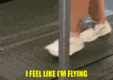 a person is running on a treadmill and the words i feel like i 'm flying are above them .